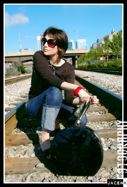 Fashion model poses on train tracks for Vogue Assassin shoot by photographer Jason Kraynek