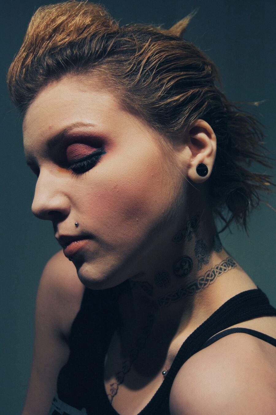Punk rock photoshoot with blonde chicago girl looking down with heavy makeup