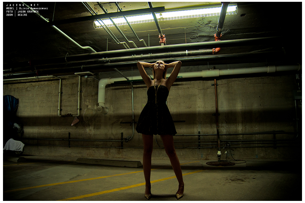 Model Olivia Banaszewski in a parking garage with harsh ceiling light from the photoshoot 'Desire' by Jason Kraynek
