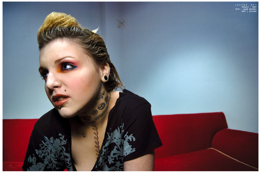 Punk rock photoshoot with blonde chicago girl sitting on red couch