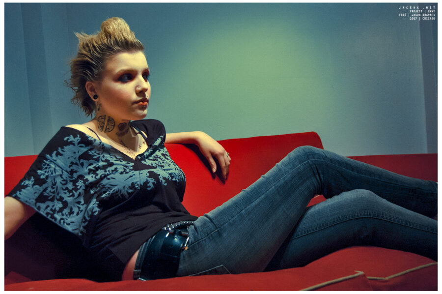 Punk rock photoshoot with blonde chicago girl sitting on a red couch