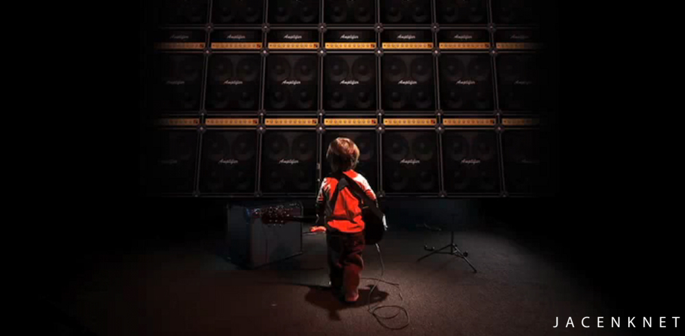 kid in front of a large speaker stack