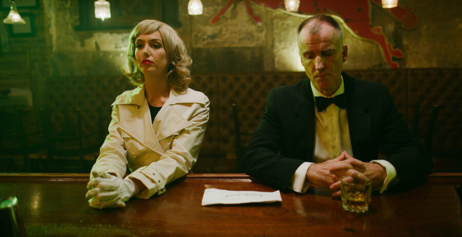 man and woman sit at a lounge bar in the short film 'the Handoff'