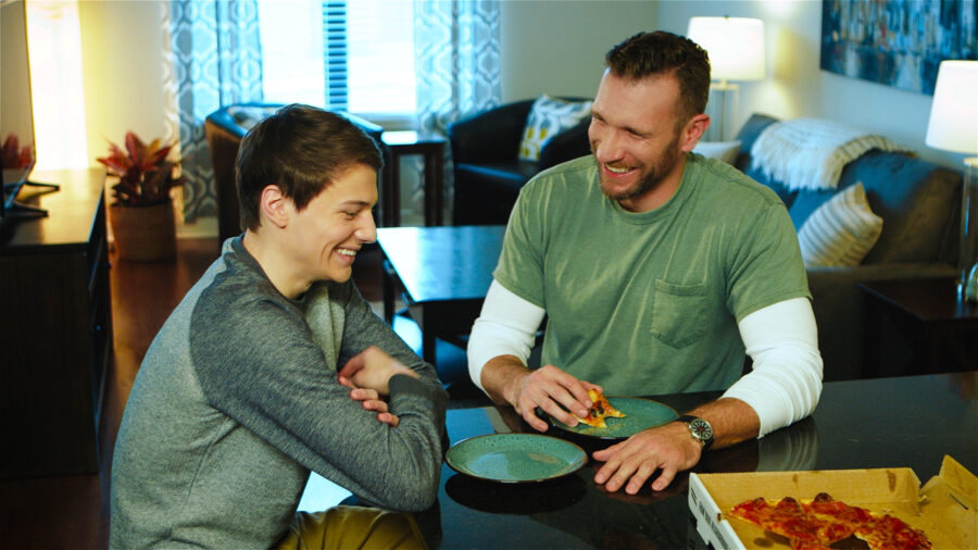 AVMA Life ad campaign actors laugh while eating pizza in a apartment shot by cinematographer Jason Kraynek
