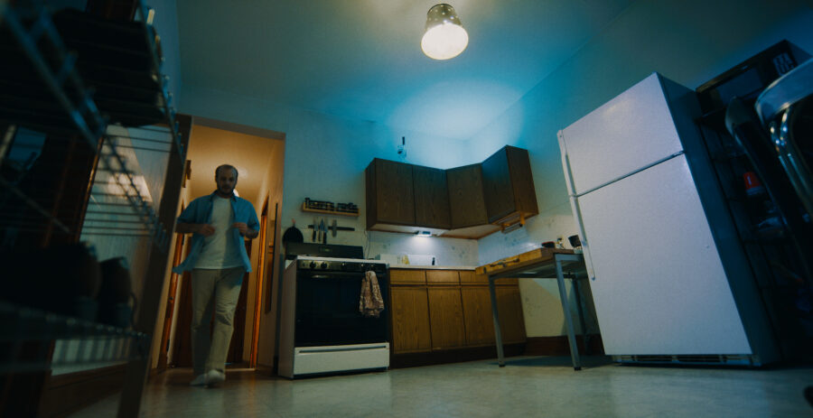 Music Video frame grab, Ganser - Psy Ops, man walks into kitchen