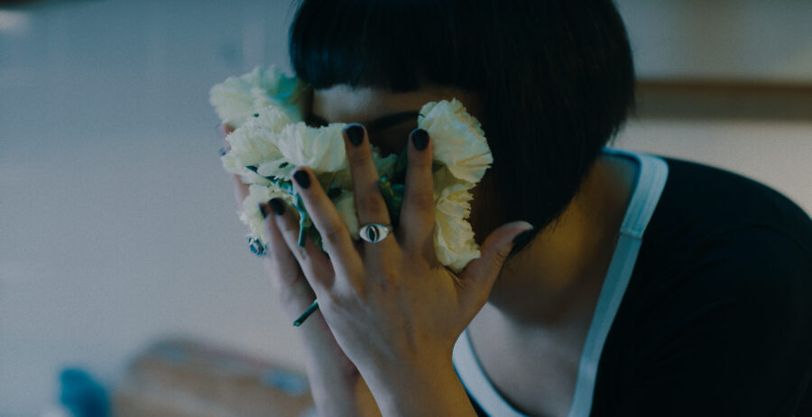 Music Video frame grab, Ganser - Psy Ops, woman smashes face into flowers