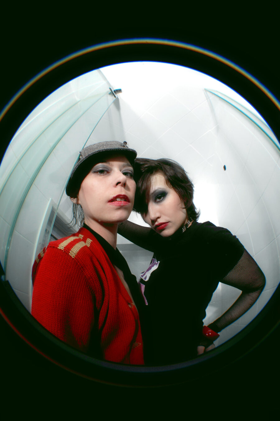 Fisheye lens with female models standing in a bathroom.