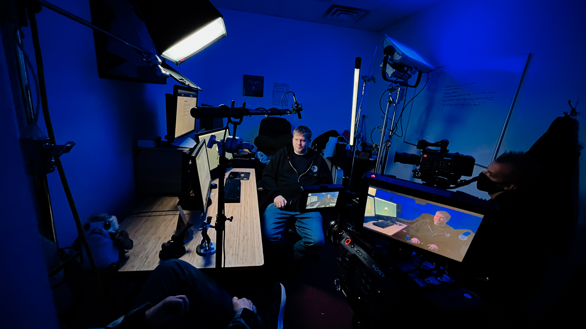 behind the scenes documentary crew shoots man in blue light