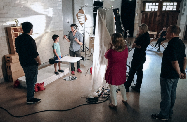 Behind the scenes on a commercial video set with lighting and cameras.