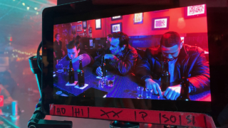 Behind the scenes shot of a red bar scene from the feature film 'FANG' shot by cinematographer Jason Kraynek