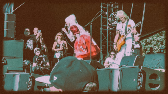 Female musicians from lunachicks at riot fest performing with microphone and guitar.