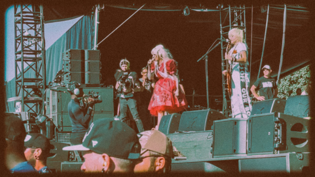 Female musicians from lunachicks at riot fest performing with microphone and guitar.