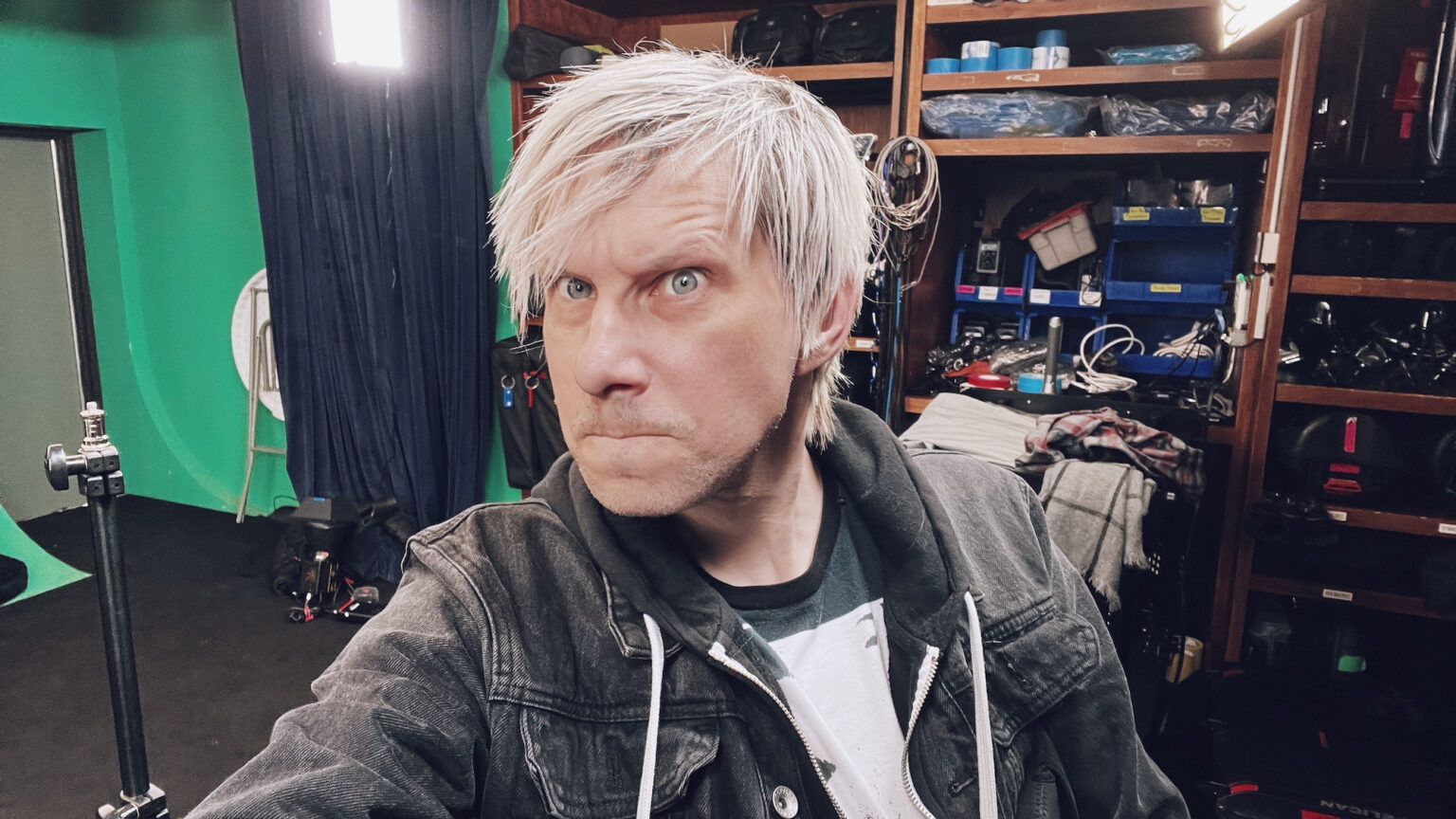 Melter – Self Titled EP | behind the scenes | Jason Kraynek Behind the scenes image of man with white hair looking into camera during a photoshoot.