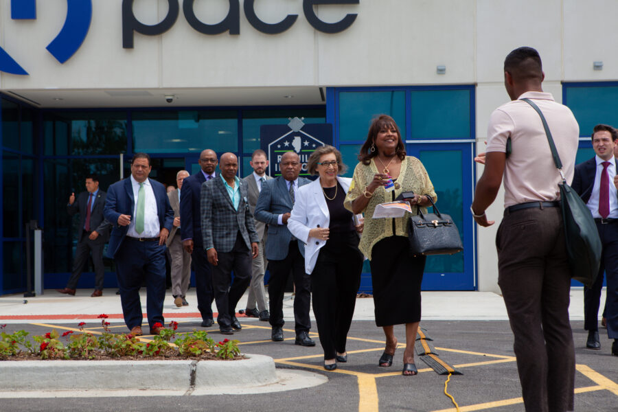 A line of people exit a building.