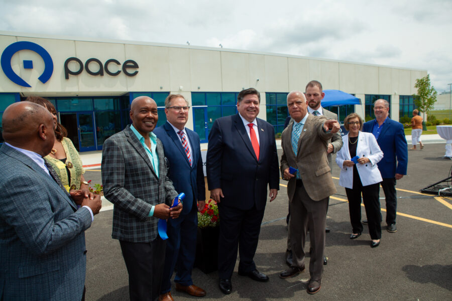 A group of people in suits outside of a building.