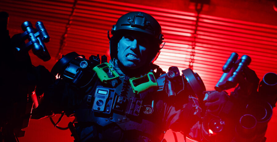 Actor in a advertisment campaign short film for Steel Supplements in a robotic suit of armor against a red wall of light