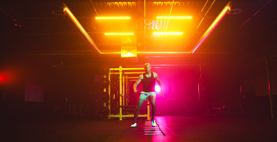 High performance workout routine by instructor in a vividly lit gym by Cinematographer Jason Kraynek.