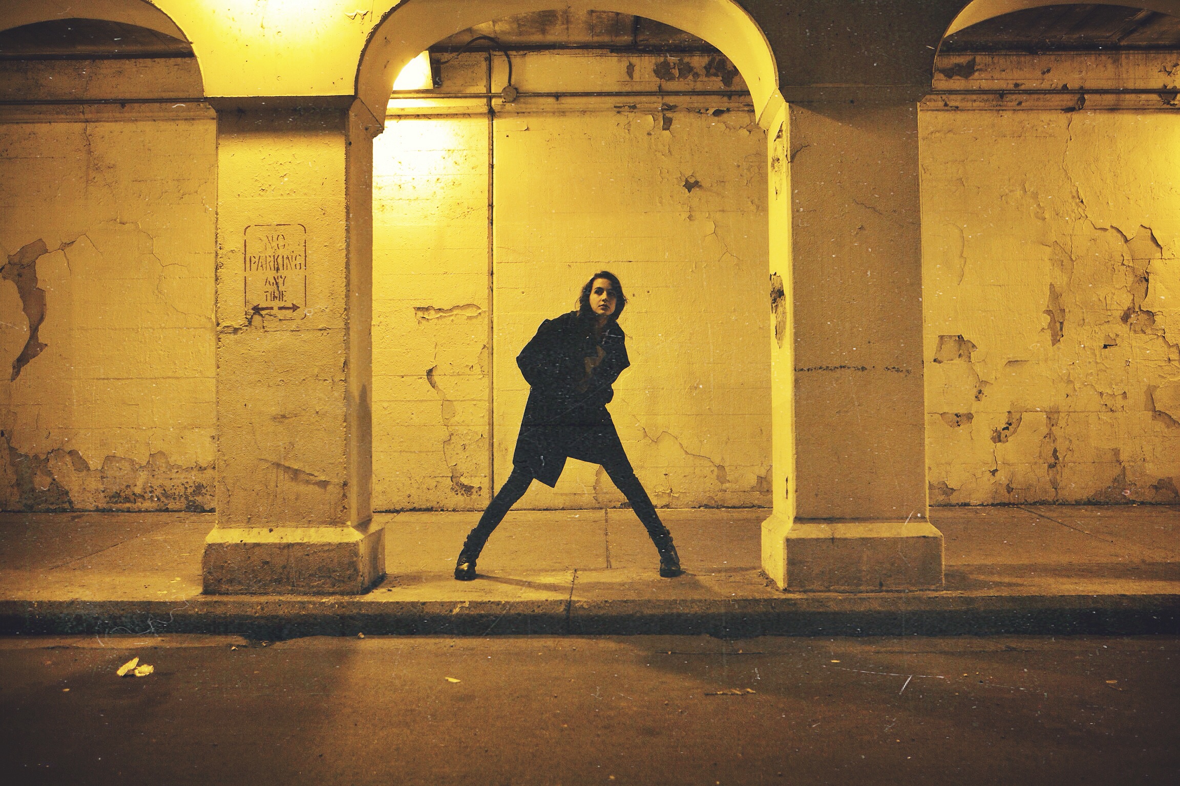 model in street tunnel with long jacket
