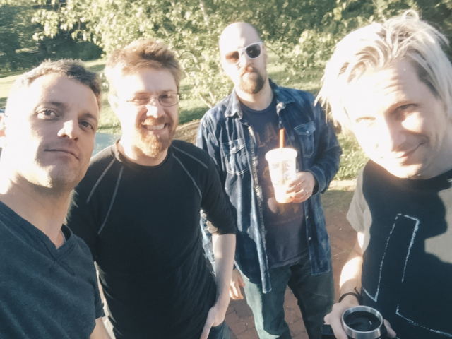 Crew standing outside in the sun during the filming of the short 'Tower Town'.