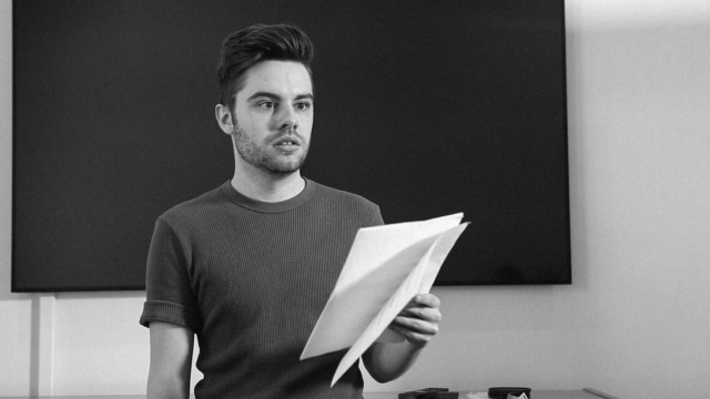 Man reads lines during a audition for a film project in a empty room.