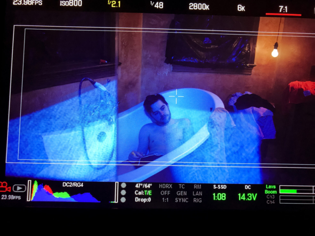 Behind the scenes production of a man in a bathtub shot by a RED camera during 'Tower Town'.