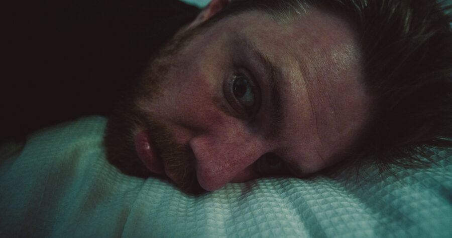 a man, robert felker, wakes up in a hotel room bed in a short film by jason kraynek shot on red epic cameras
