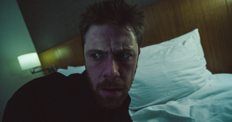a man, robert felker, wakes up in a hotel room bed in a short film by jason kraynek shot on red epic cameras