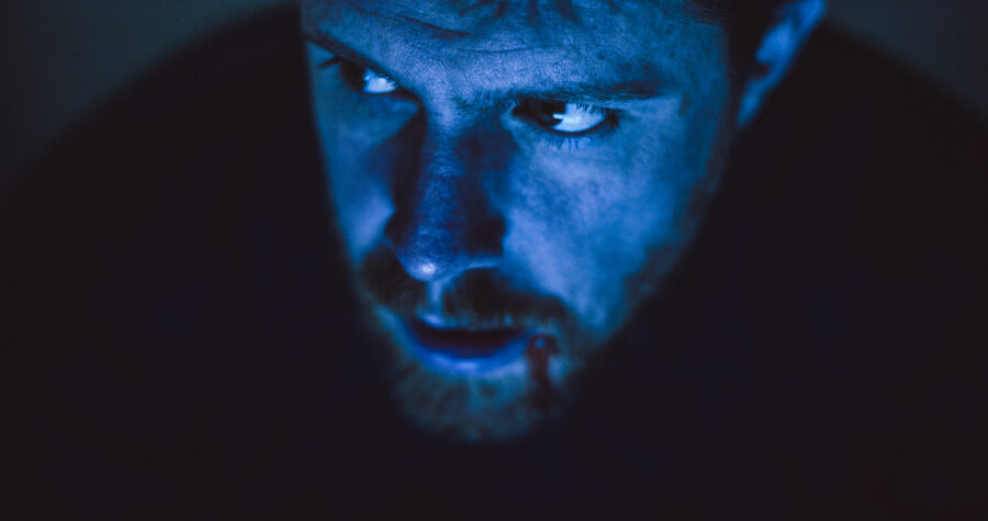 a man, robert felker, looks at a laptop in the dark in a short film by jason kraynek shot on red epic cameras